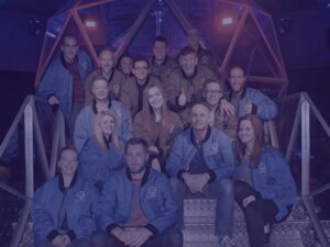 Group team photo at the crystal maze for christmas party with blue image overlay