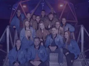 Group team photo at the crystal maze for christmas party with blue image overlay