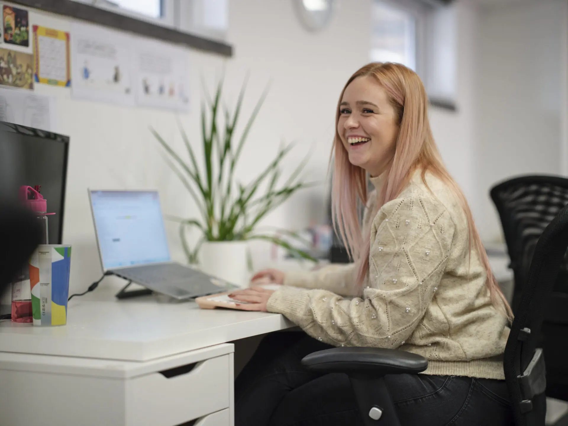 full colour Charlotte Black sitting at her desk in the Footprint Digital office