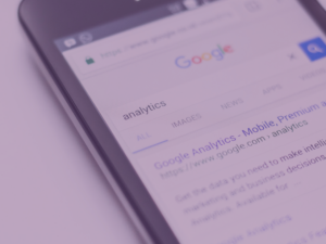 Google search for 'analytics' on a smartphone with purple image overlay