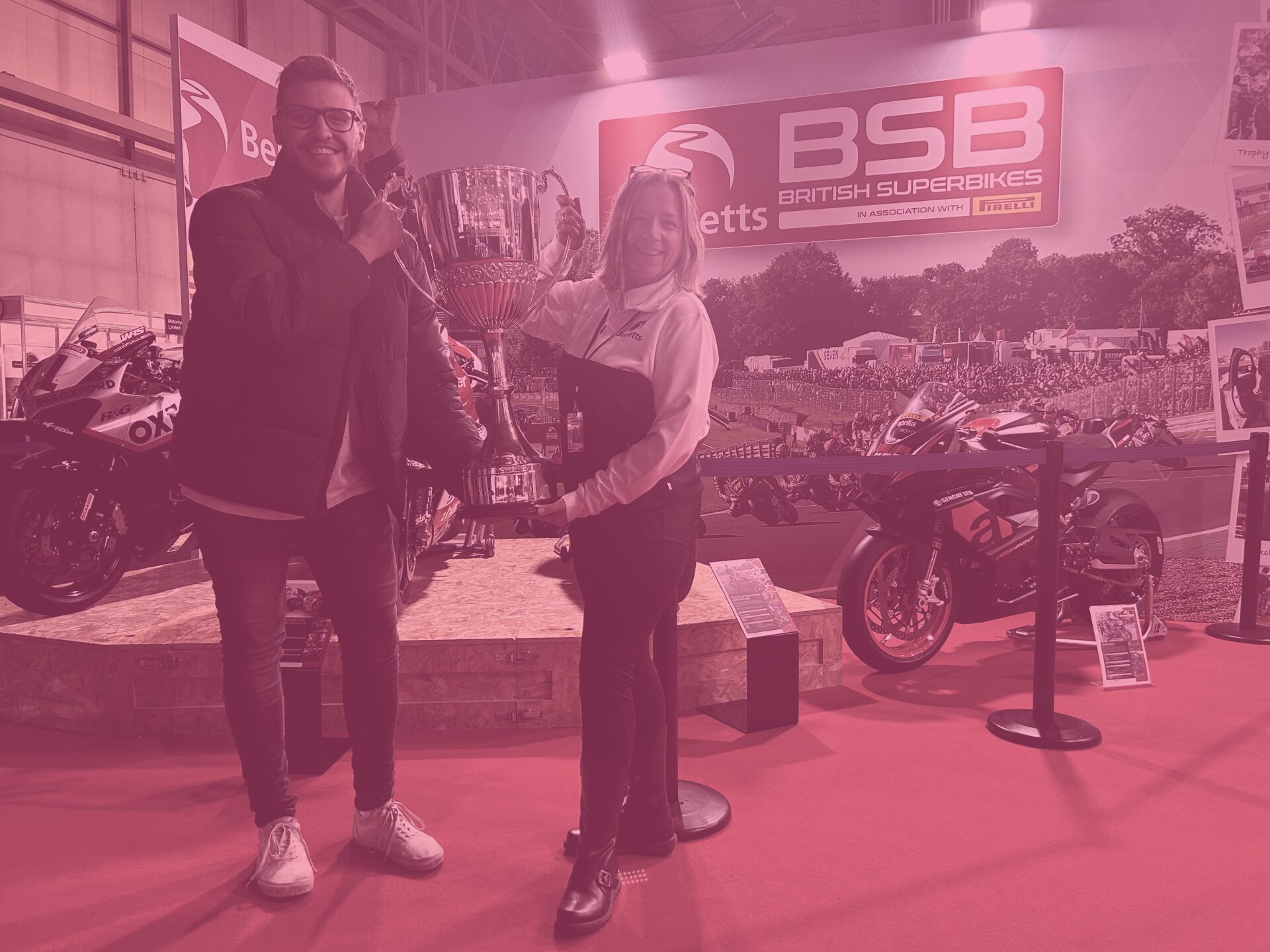 Pink Tom C and Marissa from Bennetts holding trophy at BSB British Superbikes