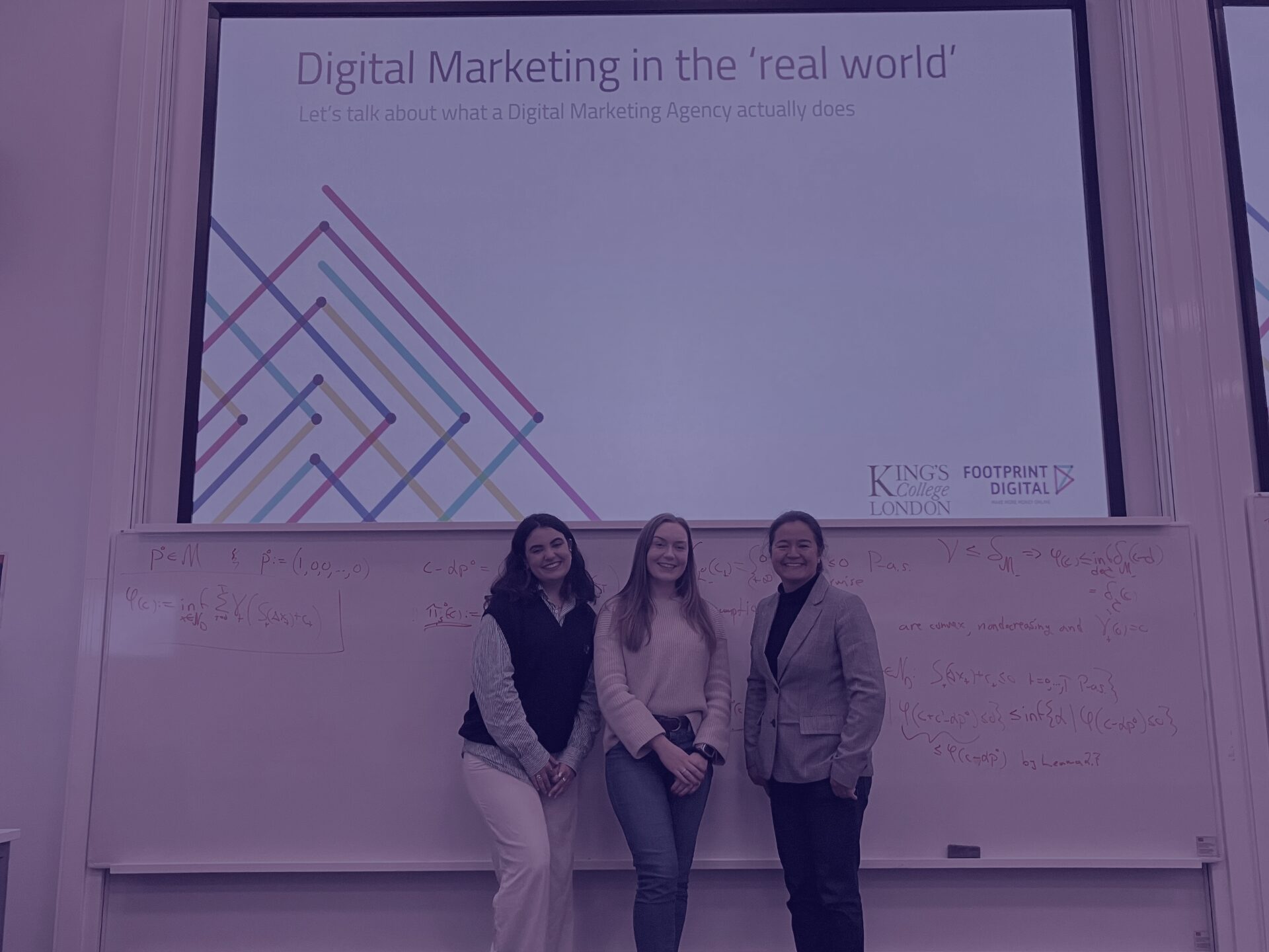 Purple university lecture - Kaya, Alex, and Sally in lecture room at Kings College London