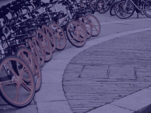 Navy bicycles in a row with orange wheels