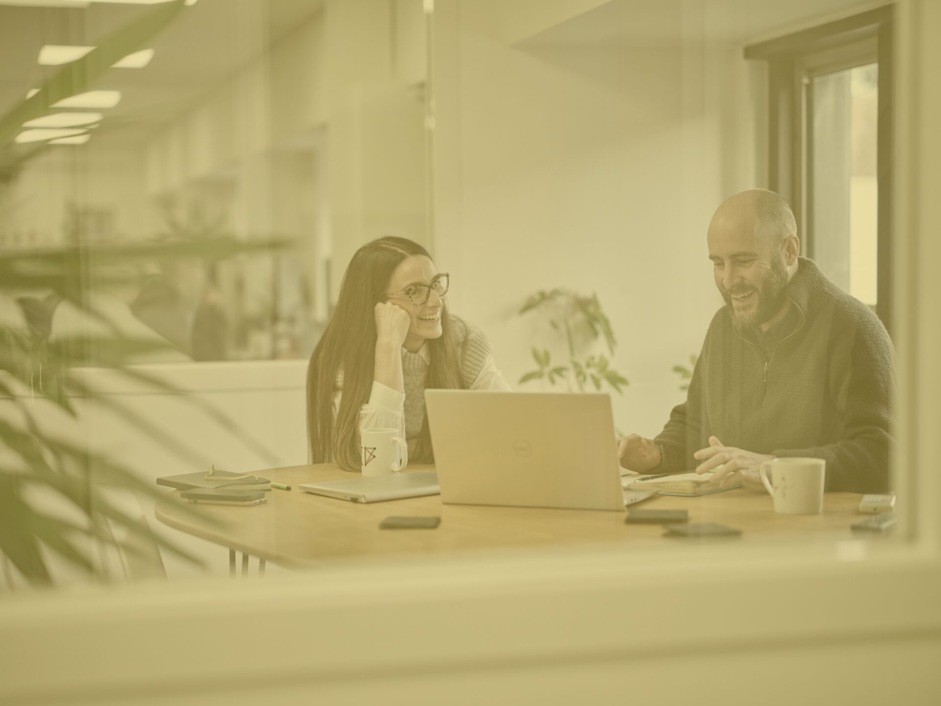 Tom and Keeley in the office, meeting room 2, on a call, yellow image overlay