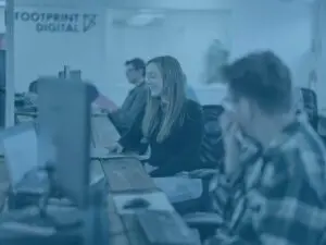 Team main office shot, Alex, Kieran, Tom C at desks blue image overlay