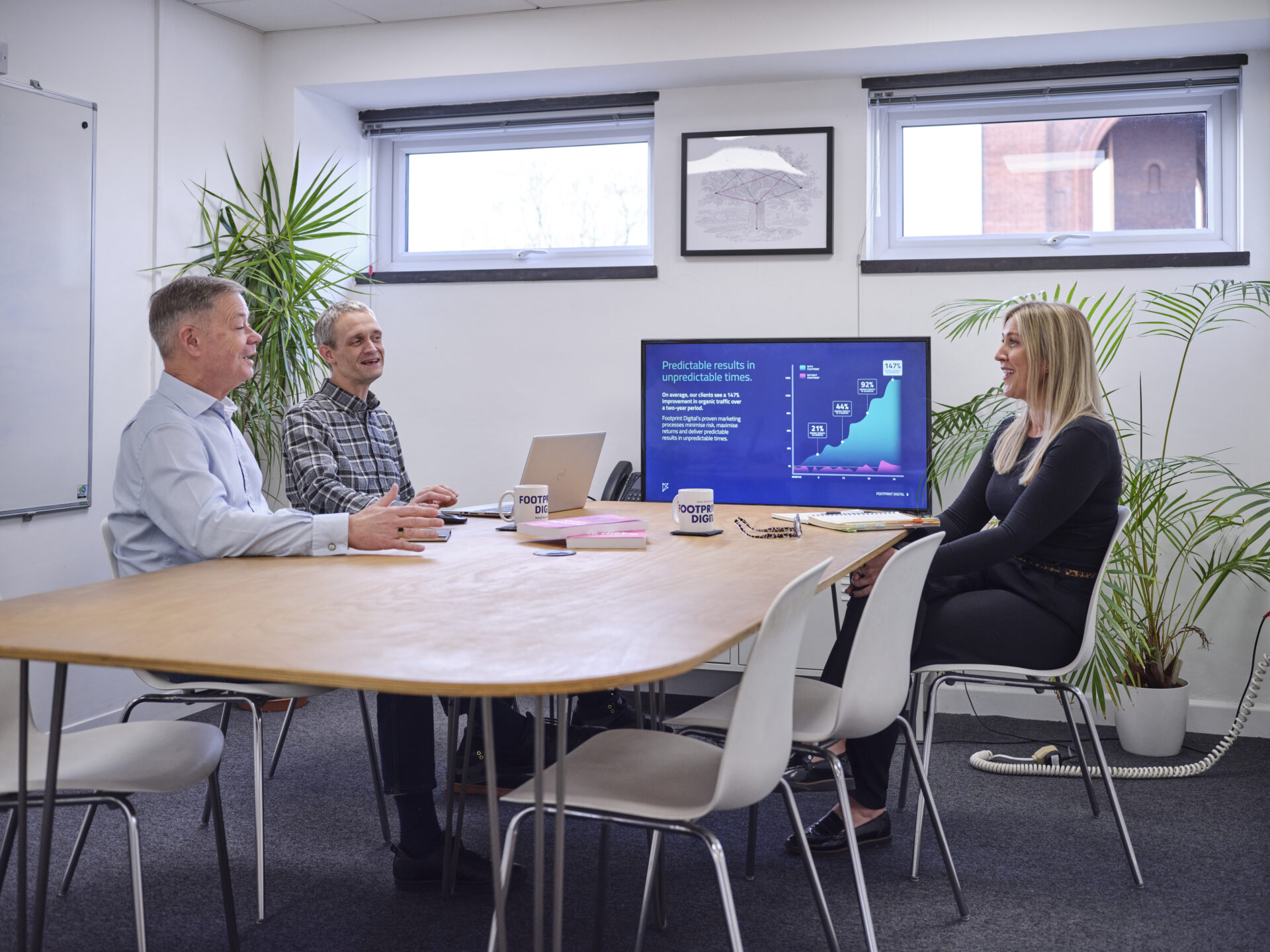 Full colour office shot in meeting room 1 with Jon, Dave, and Sarah