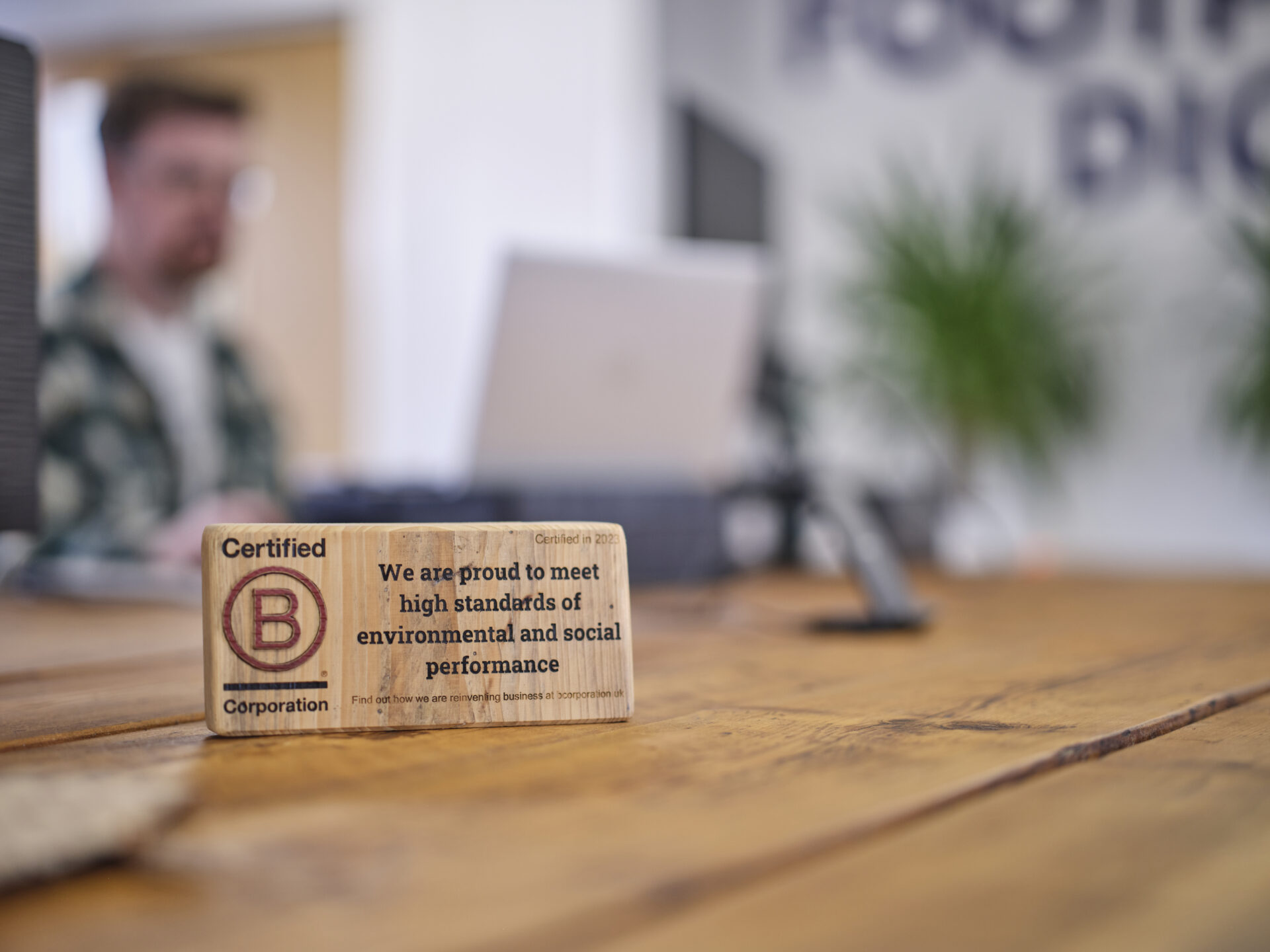 Full colour Certified B Corporation plaque in the office